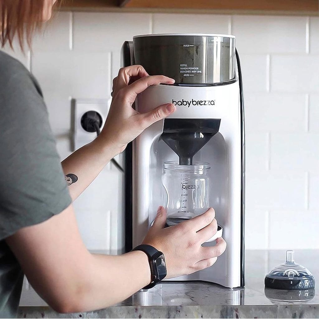 a woman using a baby brezza machine